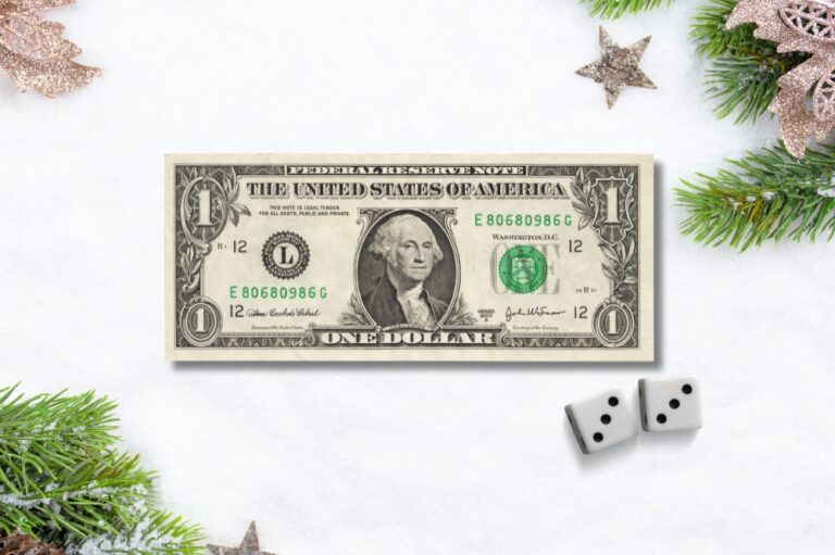 dollar bill with dice on a christmas themed background